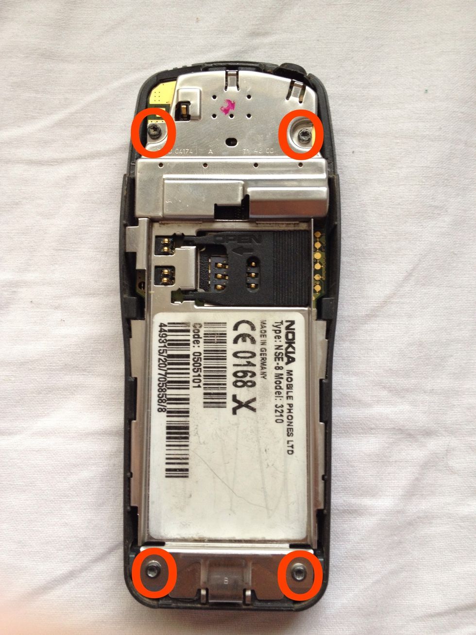 Undo the highlighted screws with the torx screwdriver.