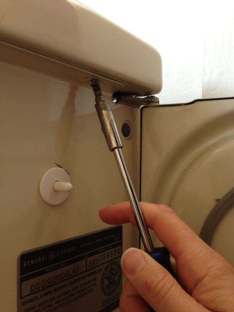 Undo the screws inside the door that are facing up into the top. Put the screws in a safe place for easy reassembly. You should be able to lift the lid up now.
