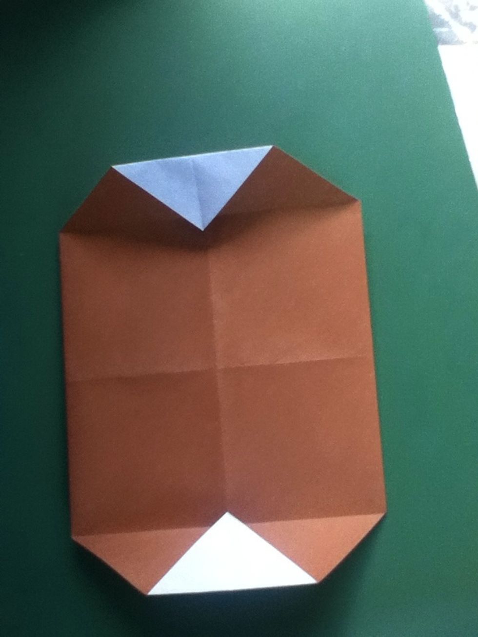 Unfold and fold the same corners to the creases just made