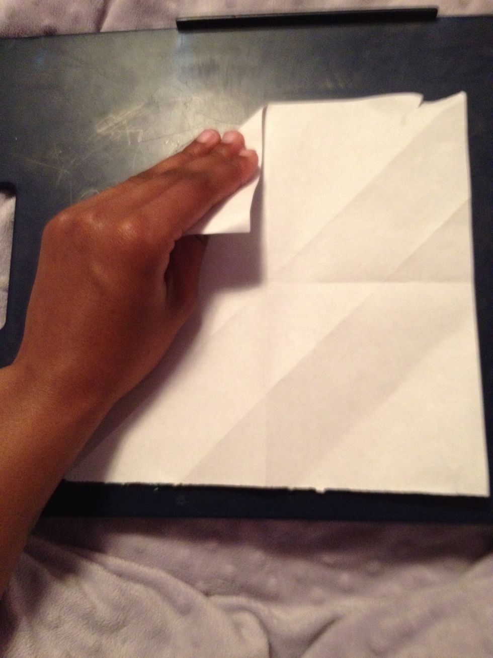 Unfold and then fold in each corner.