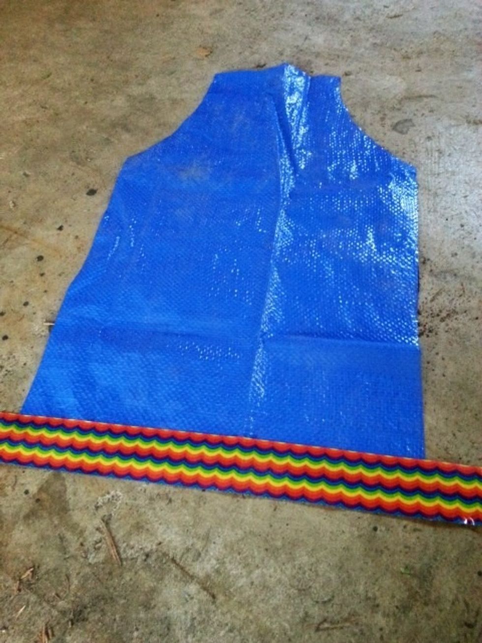 Unfold crease from last step. Put a piece of duct tape across bottom, with only 1/2 the tape on the tarp.