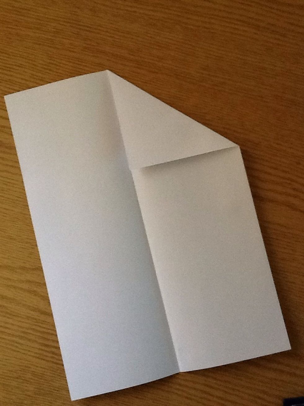 Unfold it.. Grab one corner and make a triangle making sure it's edge is on the line of fold you just made in step 1