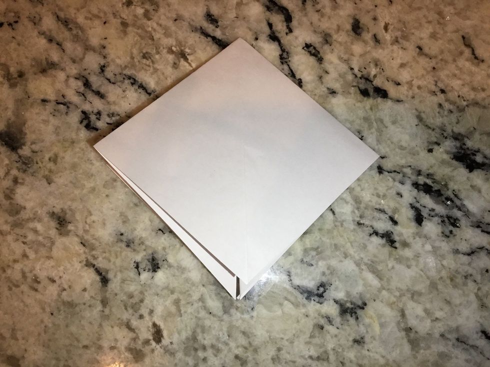 Unfold paper and bring each side in to create a small square