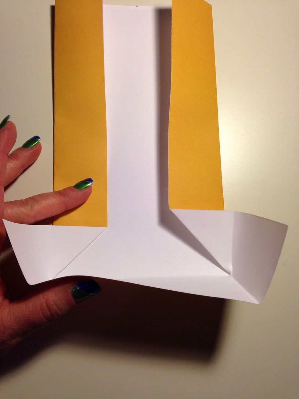 Unfold part way and back fold the flaps to stick out to the side. Advance to the next picture to see another view.