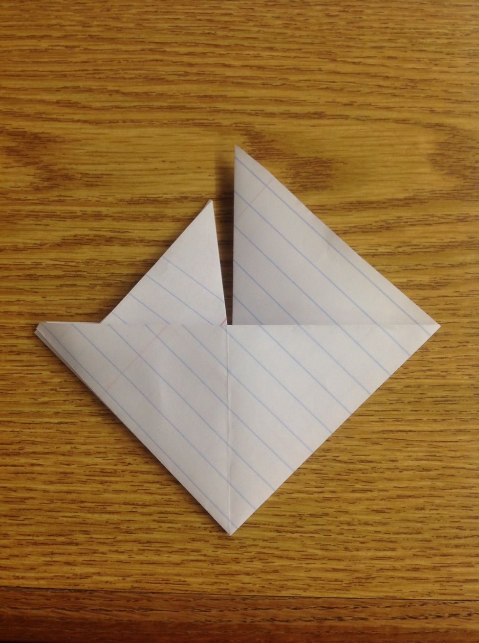 Unfold that entire triangle, and refold it into the triangle pocket beneath it.