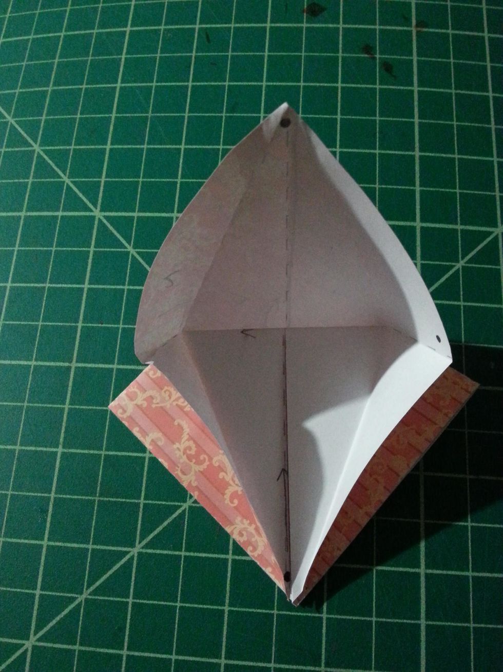 Unfold the 3 flaps and slightly pull up on the top shape. Your shape should resemble the one on the left. REMEMBER  to open up to the top fold. This is called the Petal Fold.