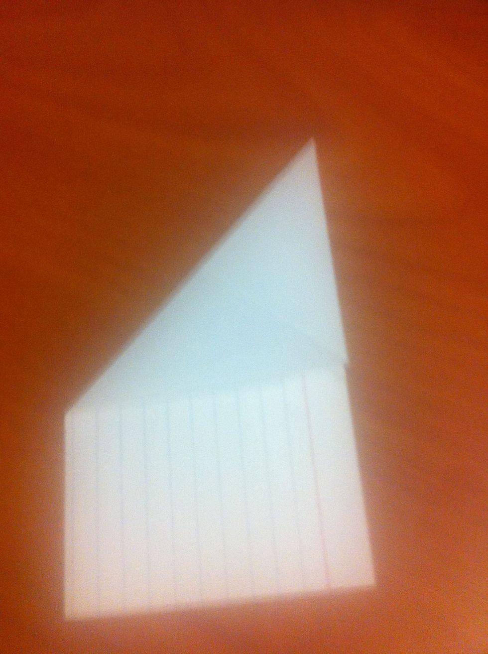 Unfold the card and then fold the top left corner down to the right edge of the card (as shown). Use your previous fold as a guide for the left corner to follow as you make the fold.