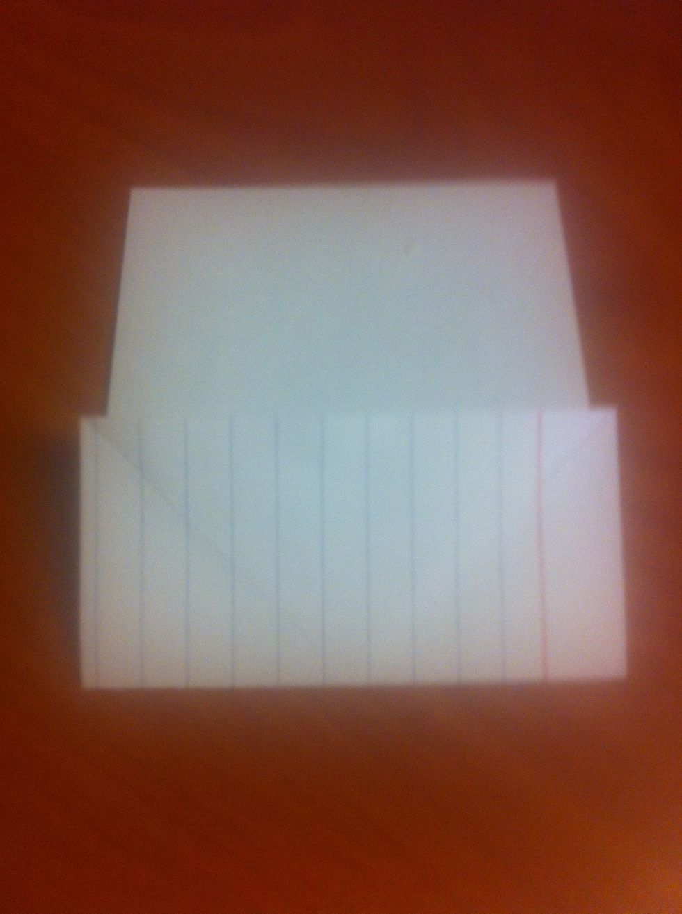 Unfold the card. Take the top edge of the card and fold it backwards. Try to line up the folds on the front and back of the card. This should form an X with a horizontal line going through the middle.