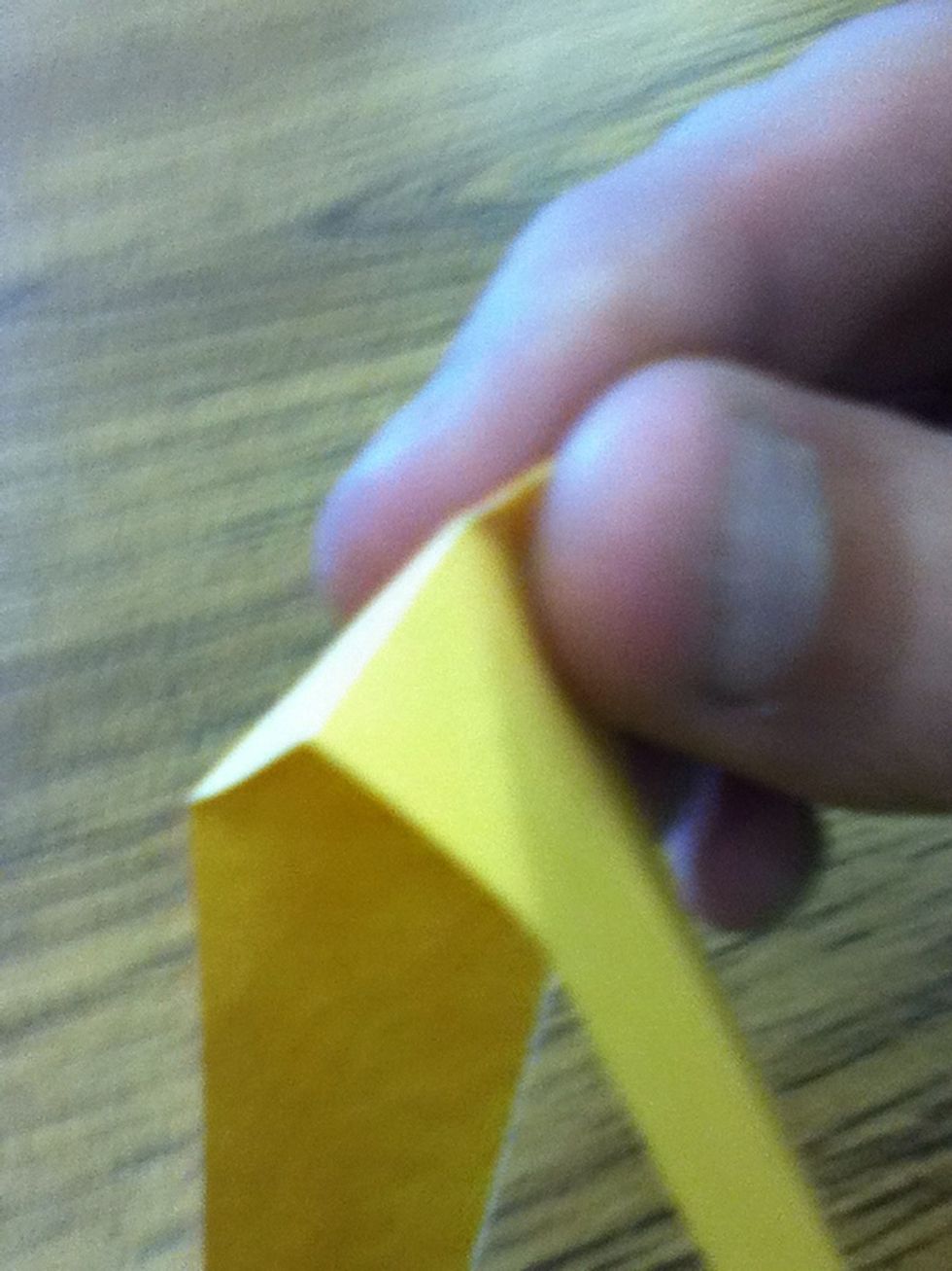 Unfold the corner and prepare to fold in the triangular area (pocket fold)