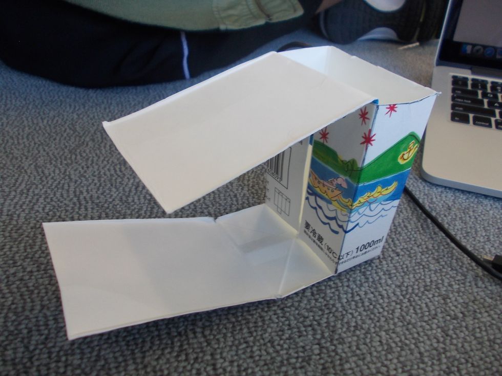 Unfold the milk carton (fold it in half)