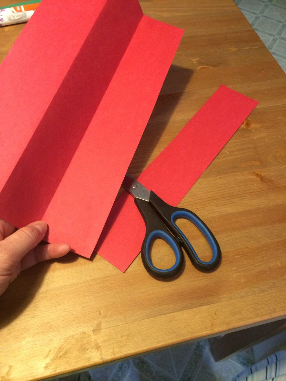 Unfold the paper and cut it into four strips, either with scissors or a paper slicer. It doesn't have to be perfectly straight.