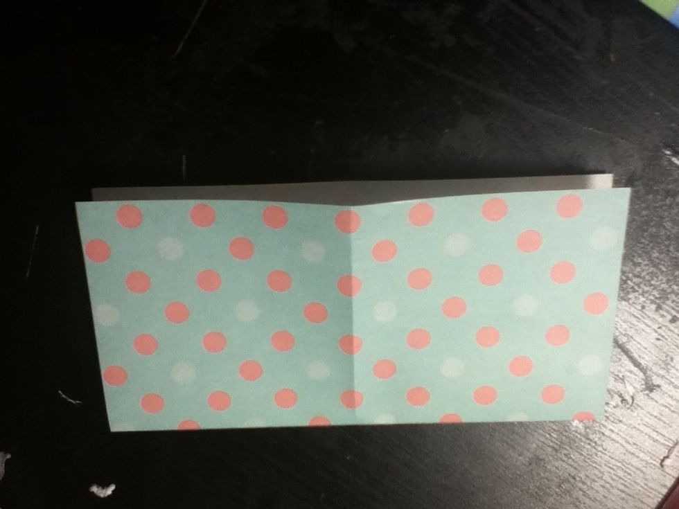 Unfold the paper, and fold in half the other way.