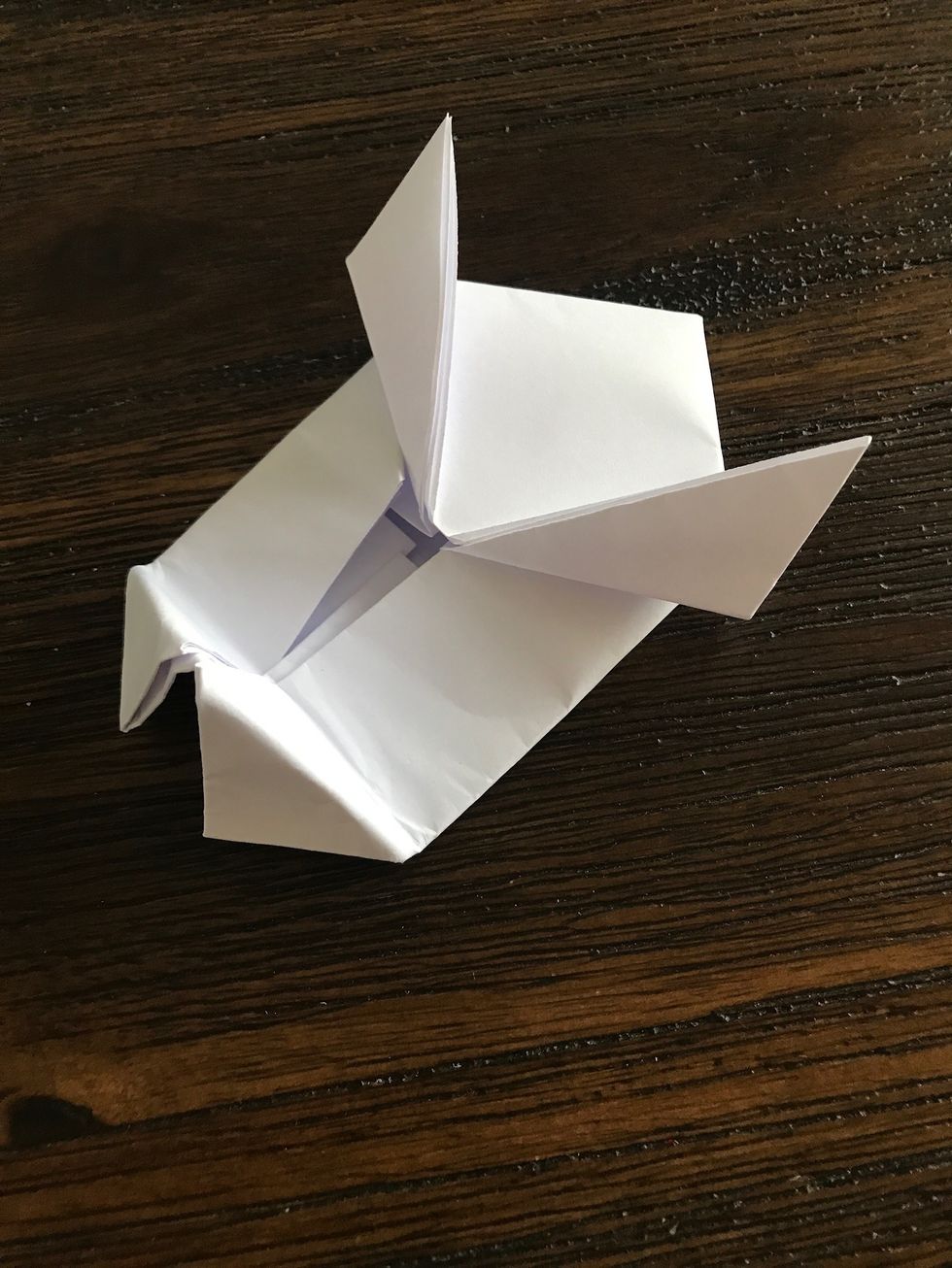 Unfold the paper downward as pictured.