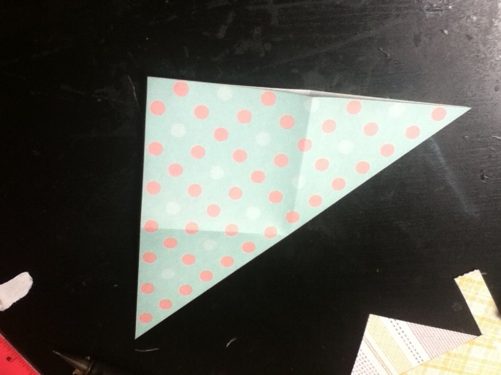 Unfold the paper, then fold it in half again into a triangle.