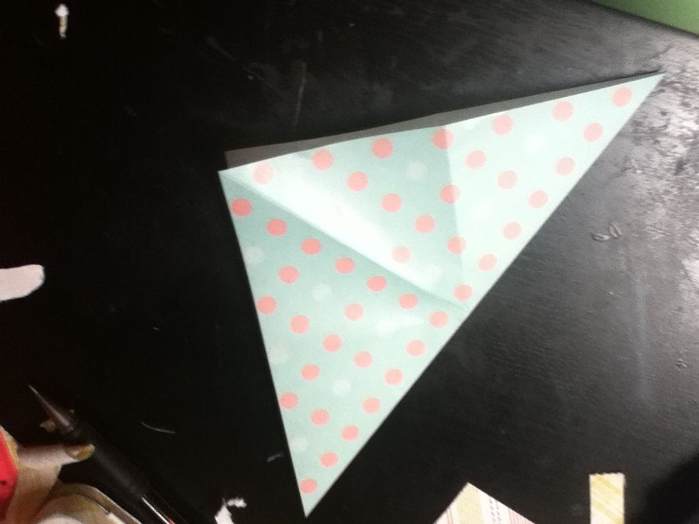 Unfold the paper, then fold it the other triangular way.