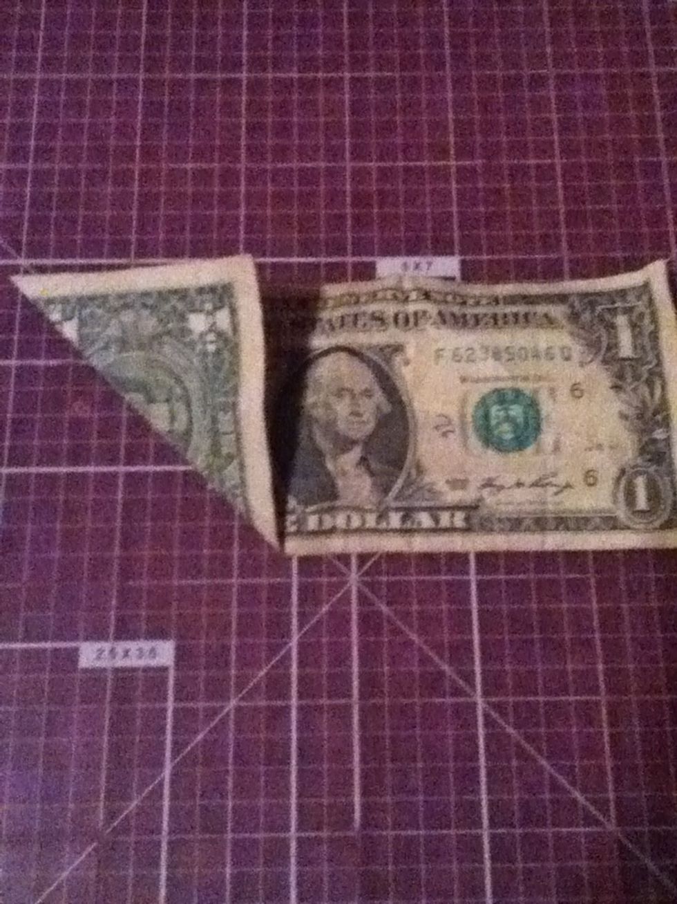 Unfold the previous crease and fold the same corner upwards