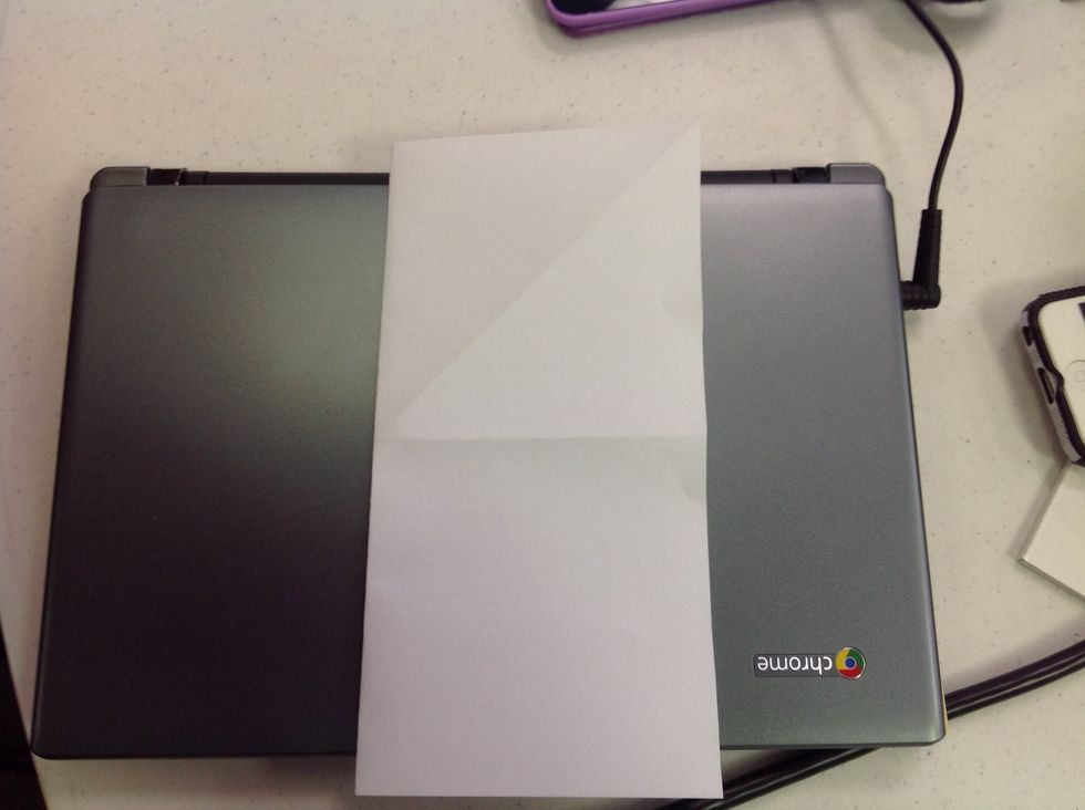 Unfold the square and then fold vertically.