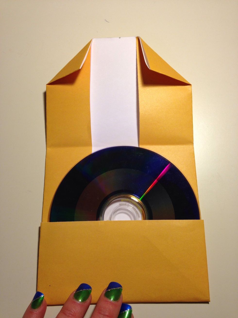 Unfold the top half. Turn down each corner. This becomes the flap to tuck into the bottom.