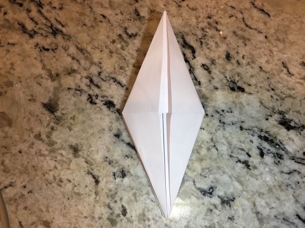 Unfold triangle then fold into the center again to create a diamond shape