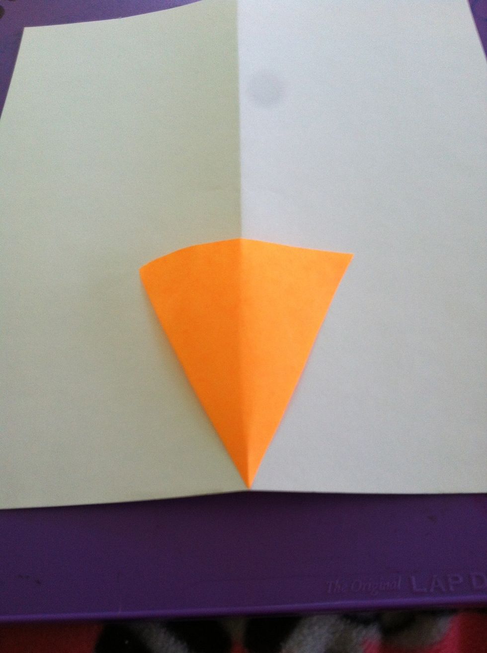 Unfold your paper and lay your carrot on top in the middle. Then trace the carrot lightly.