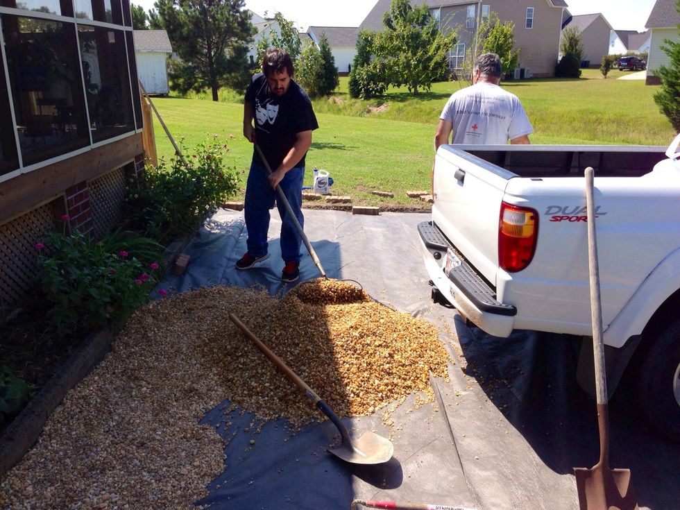 Unload gravel and spread out.