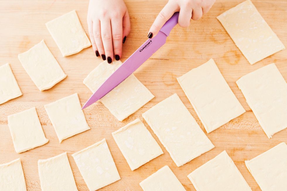 Unroll your puff pastry sheets and cut them into small rectangles. One sheet of puff pastry will yield 12 rectangles.