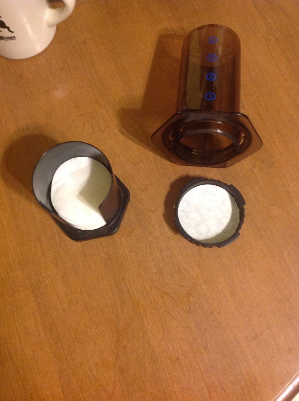 Unscrew bottom of cylinder and place a paper filter into the filter holder.