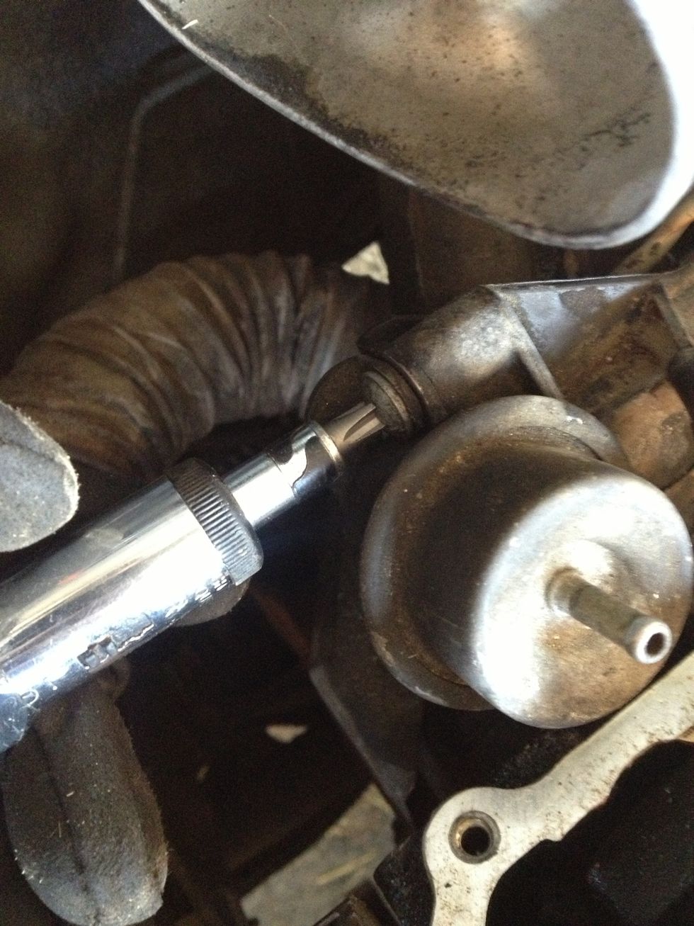 Unscrew the Phillips screws mounting the fuel pressure regulator... Top here...