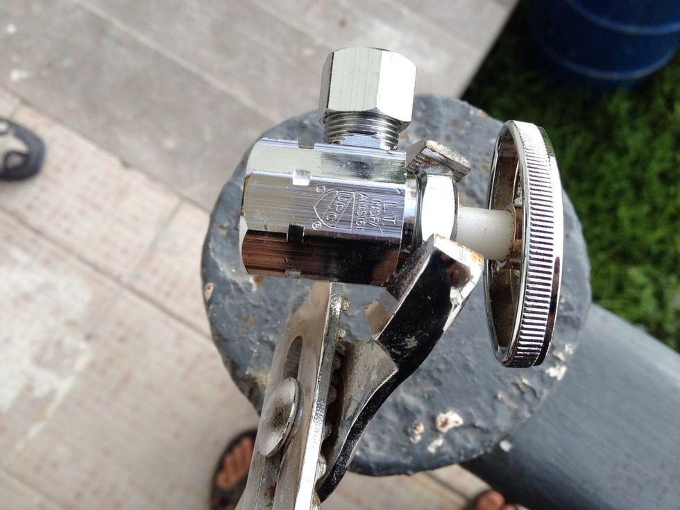 Unscrew the piece you see the wrench holding in the picture first (collar). Just loosen it with the wrench and then use your hand. Once that's loose, unscrew the little plunger by turning the handle.