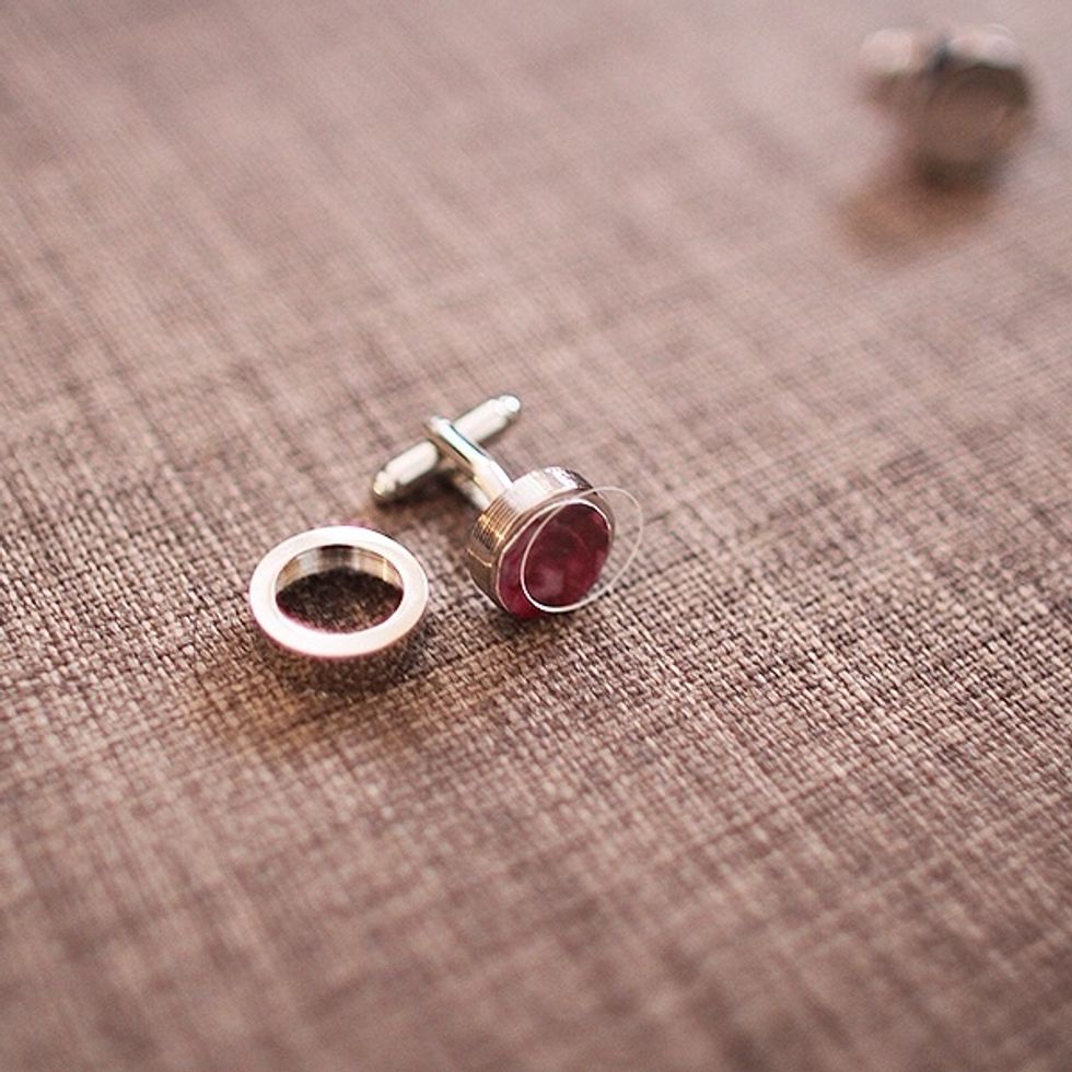 Unscrew the top of the blank cuff link (there is protective plastic disc to protect the photo inside each cuff link, so be sure not to lose this part).