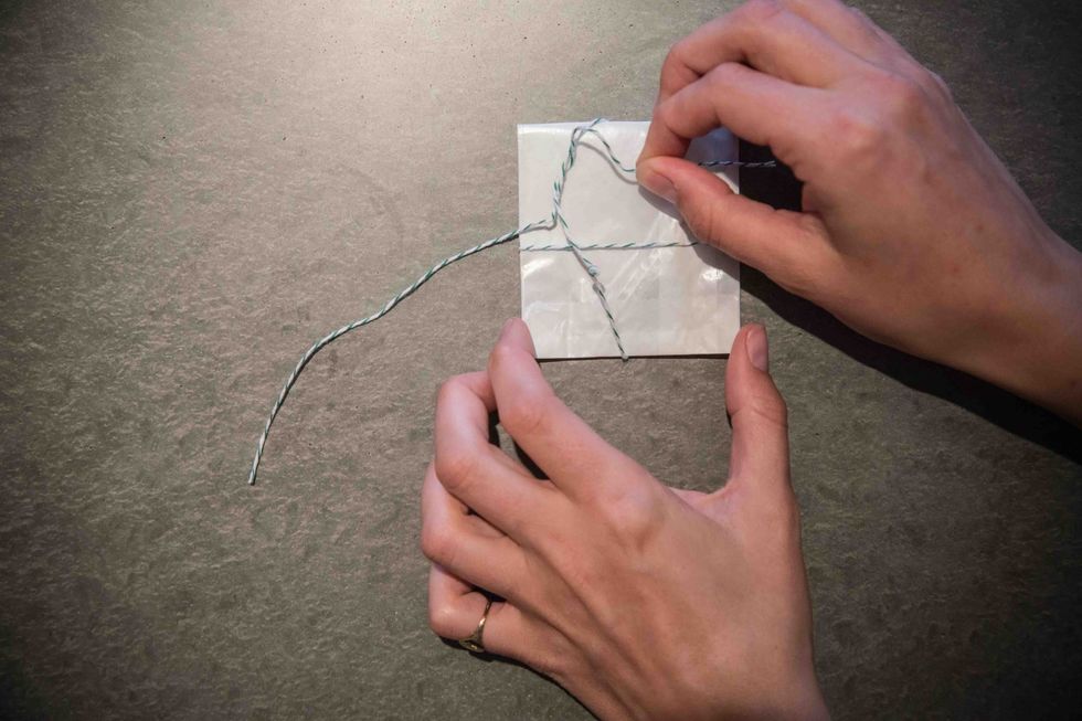 Untie the needle packet.