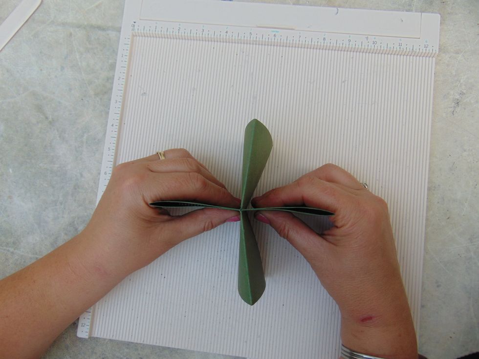 .... until you have closed this fold too. Still keeping hold of the first two flaps....