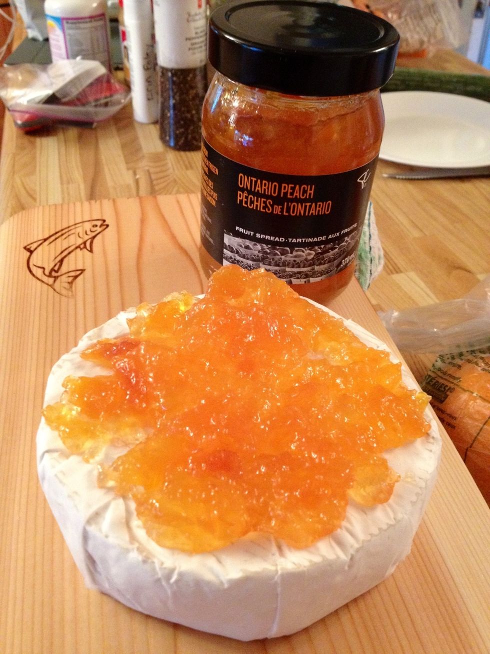 Unwrap Brie and place it on plank. Top with fruit compote.