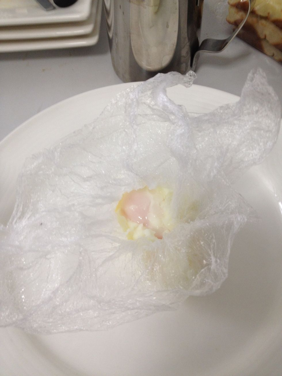 Unwrap the egg carefully. If you think your eggs are not cooked enough. Then place back in boiling water. If your wrap is not sticking together wrap some more wrap around so it's water tight.