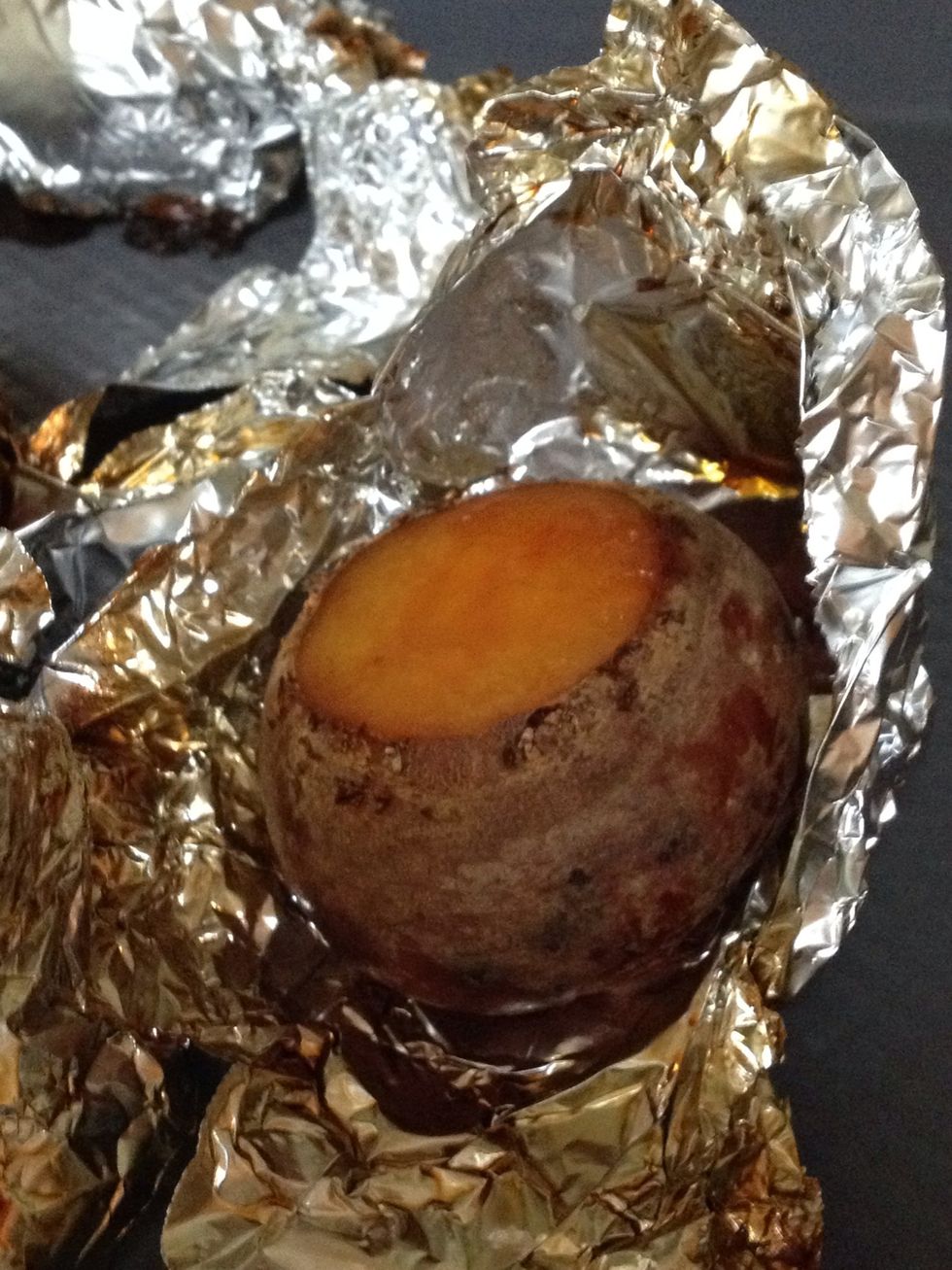 Unwrap to cool and then slip off the skins.