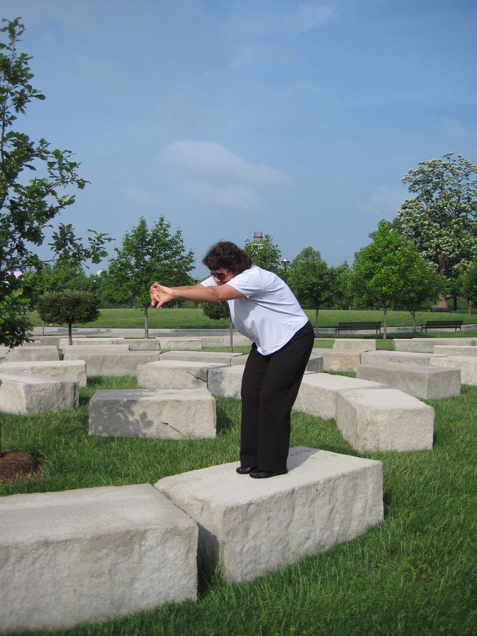 Upper back stretch \u2013 Interlace hands in front of body with arms straight out. Tuck head in between arms.