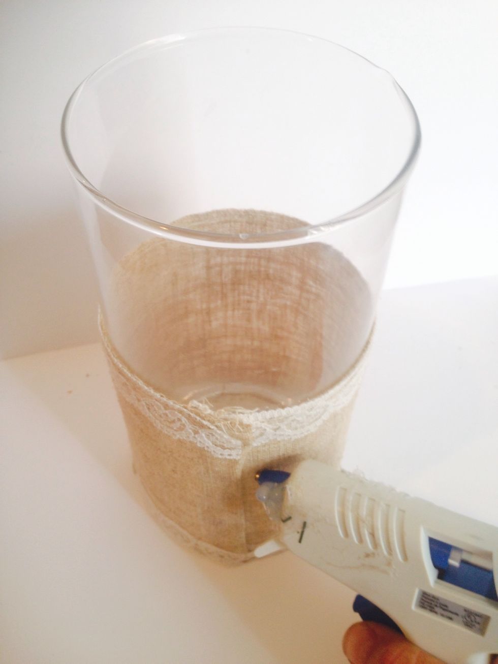 Use 6 inch burlap to measure around the base of the 12 inch votive . Secure the burlap to the votive with hot glue.
