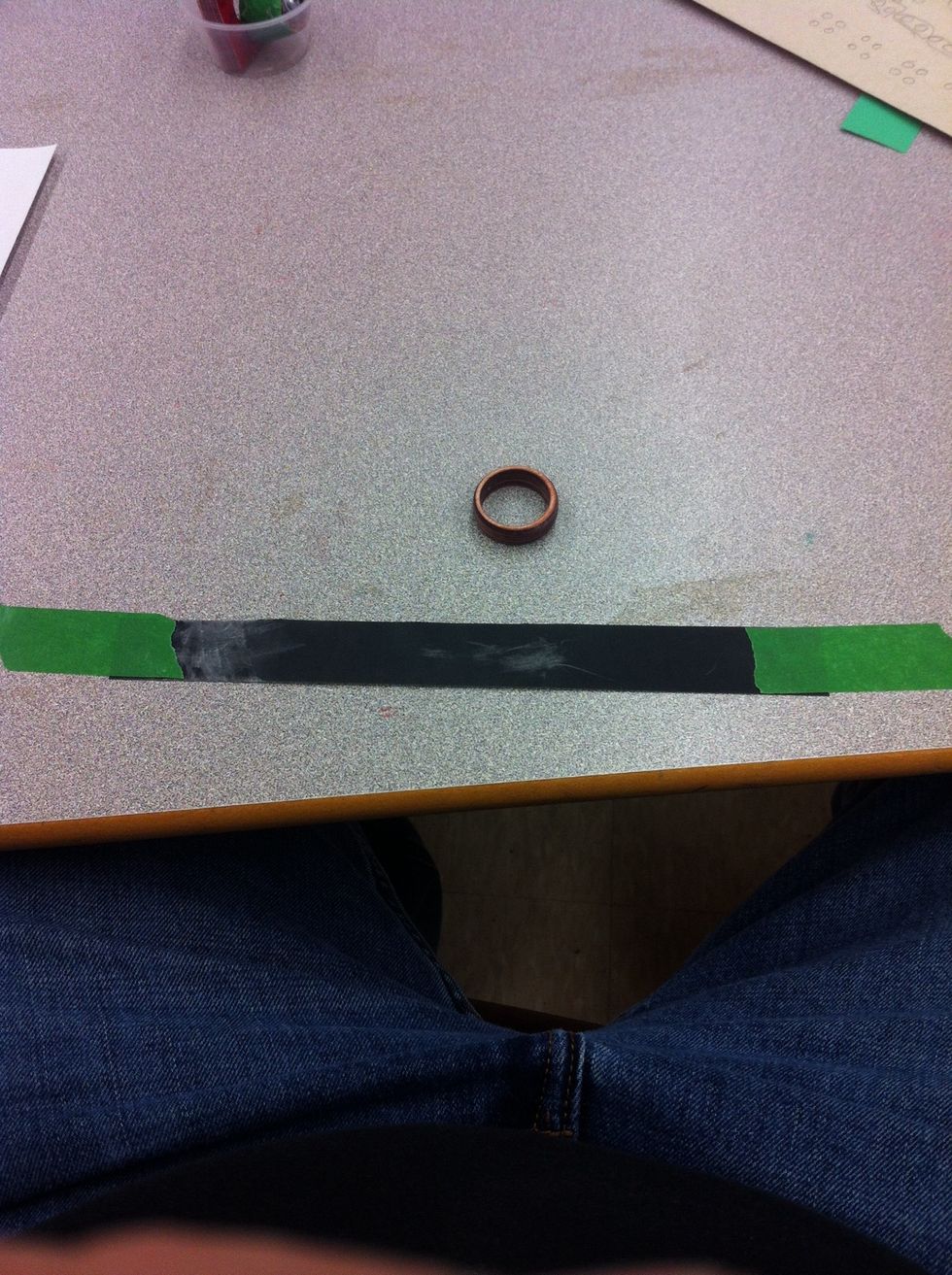 Use 600 grit sand paper to hand sand your ring.