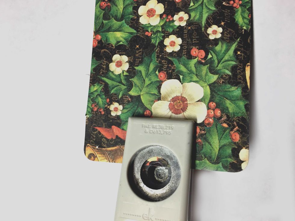 Use a 1/2" circle punch and punch just beyonond your pencil marking so that the paper will fit around the grommet.