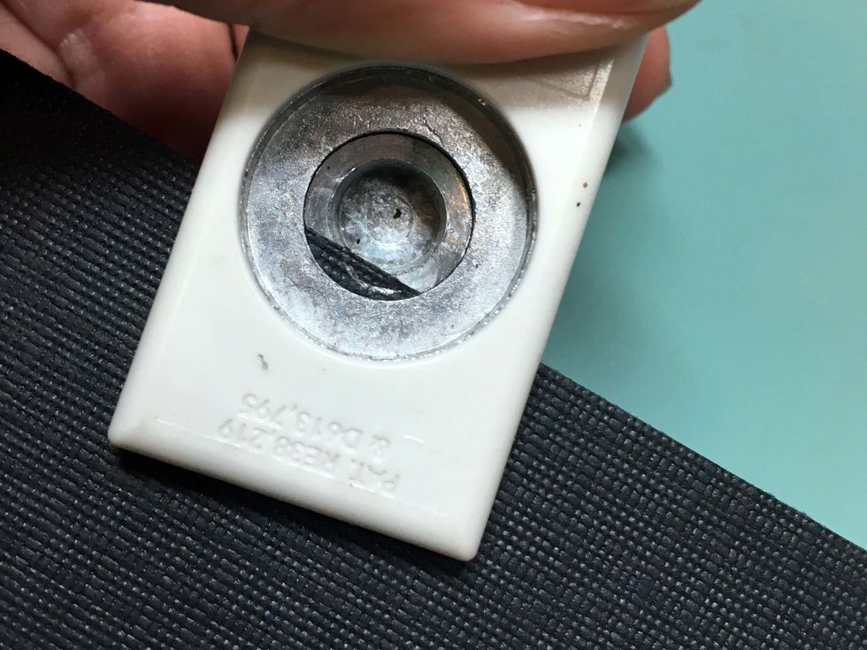 Use a 1/2" hole punch to cut away the paper that overlaps the tag's hole.