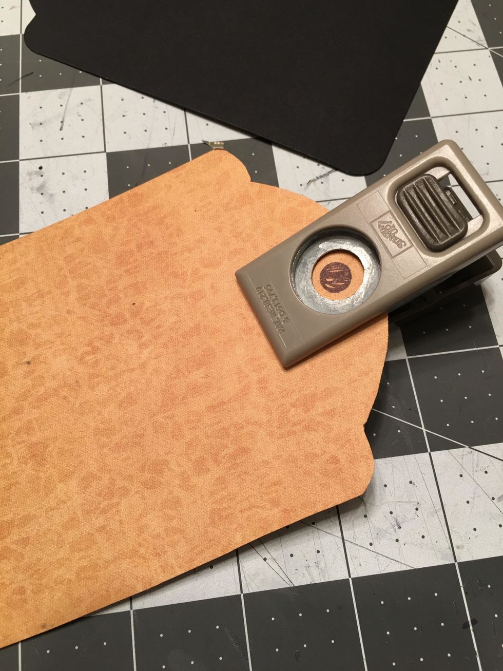 Use a 1/2 inch hole punch, to punch out the hole for the tag on the patterned paper. Make sure to center the punch over the circle you marked onto the paper.