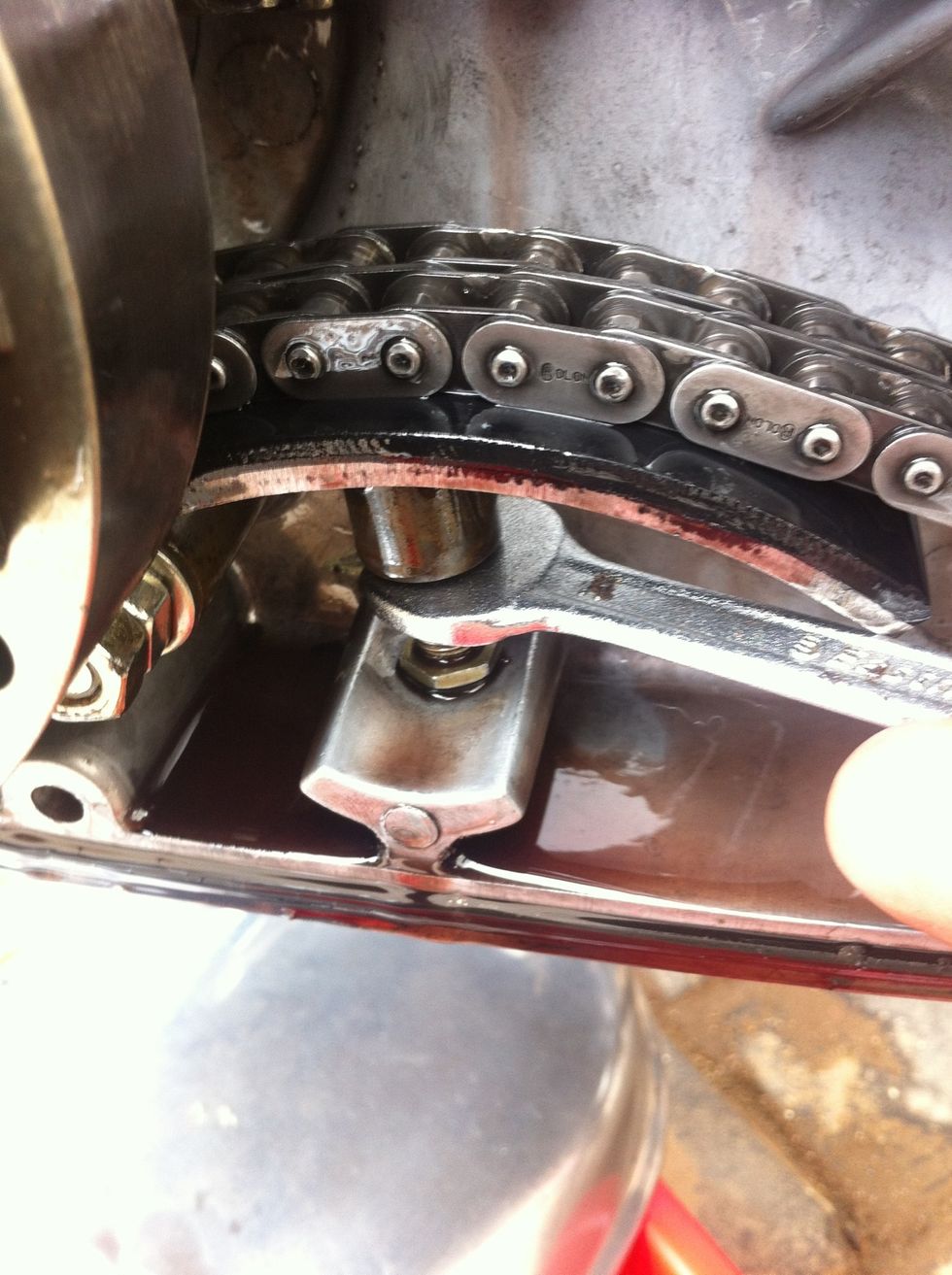Use a 11 mm spanner to loosen the lock nut
