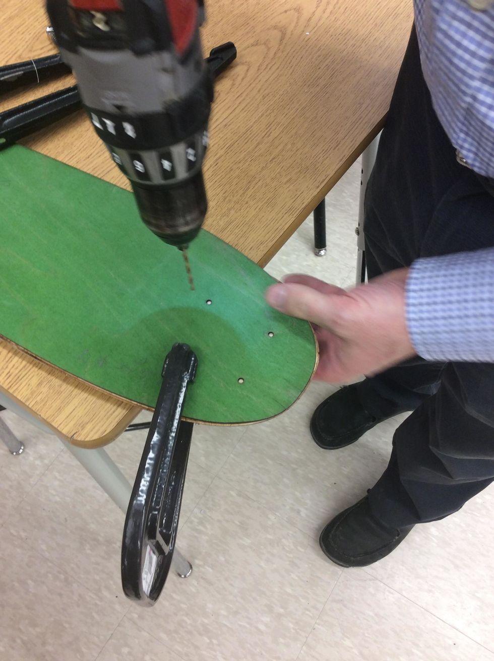 Use a 3/16" bit to drill through the hole closest to the clamp.