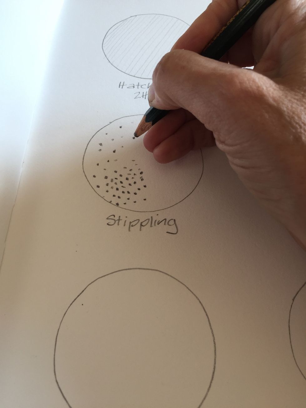 Use a B pencil. Create dots in a controlled way. Space them close together to create dark shaded areas and space them apart for light shading