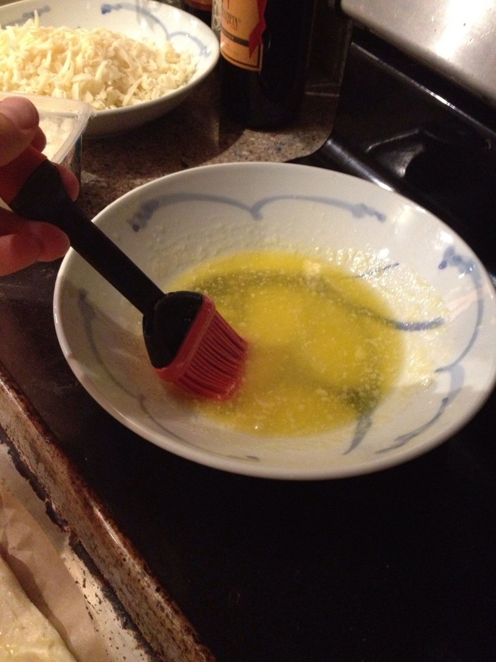 Use a basting brush and dip it in the butter.