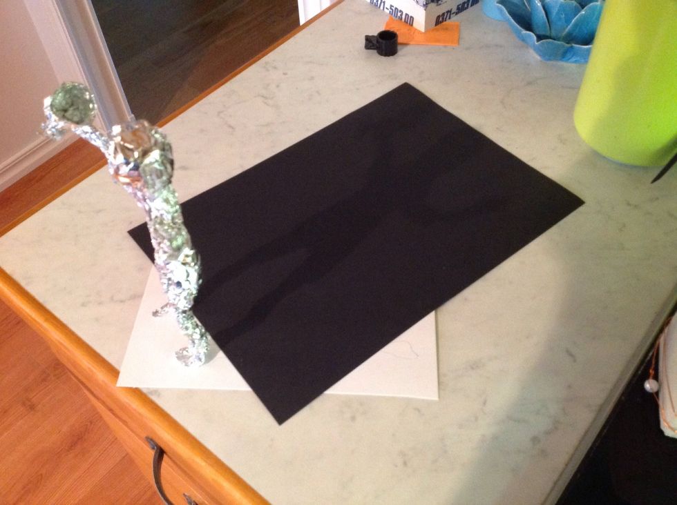 Use a bigger paper, any color you like, and then draw around the shadow.