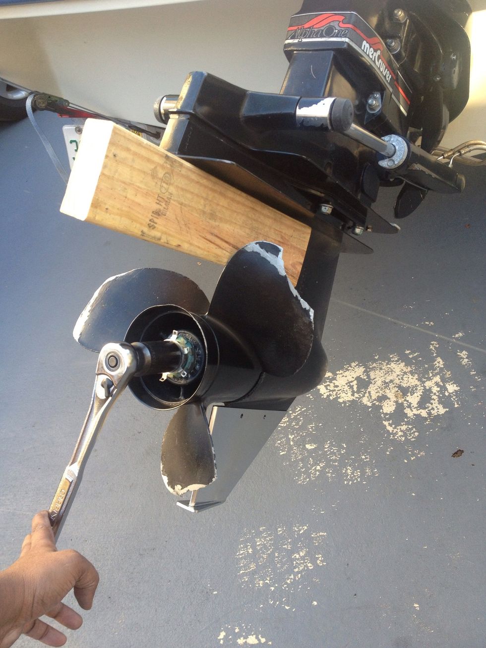 Use a block, to stop the prop from turning, then loosen the bolt