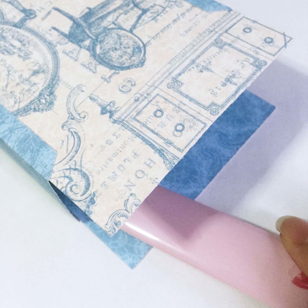 Use a bone folder, gently burnish to adhere the papers onto the tabs. This will be the completed attaching piece for the tags.