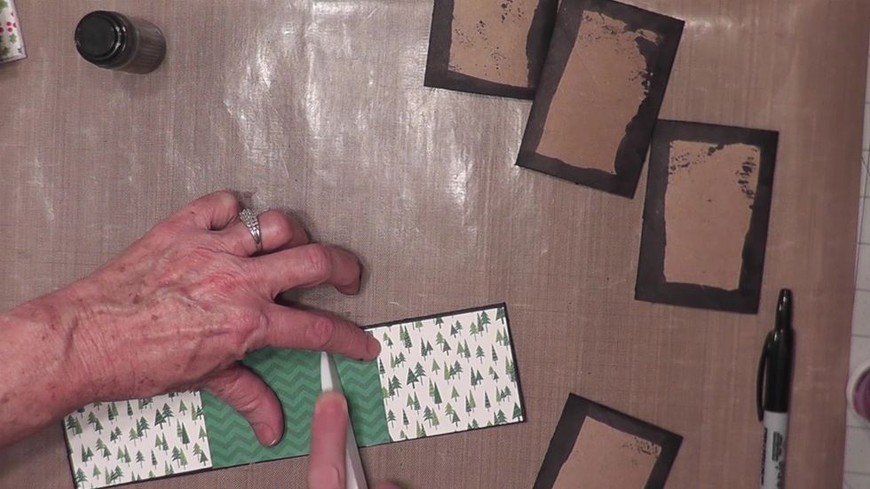 Use a bone folder to GENTLY burnish the inside spine paper along the fold line gap of the cover.