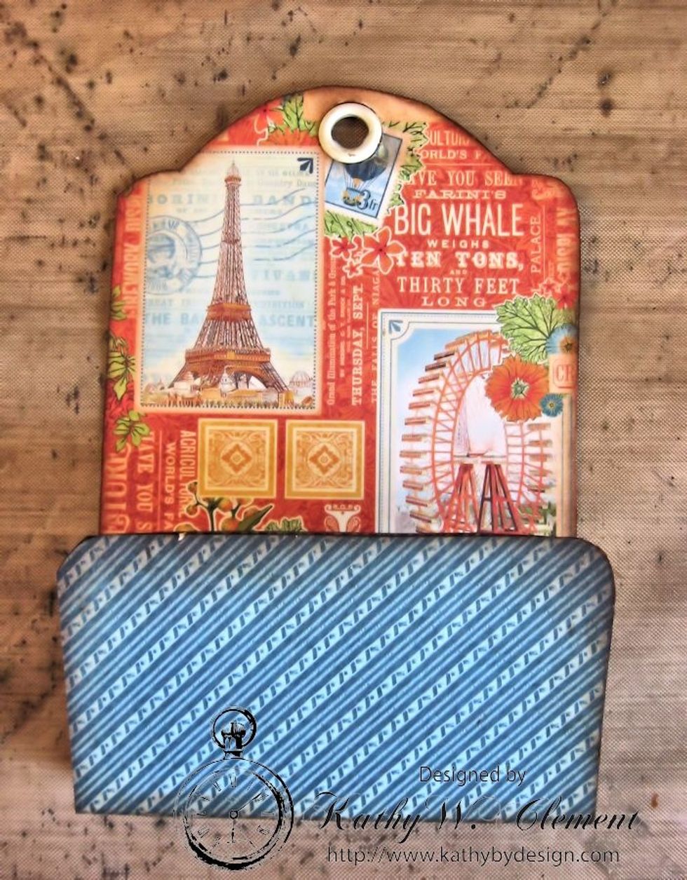 Use a bone folder to seal the papers to the ivory tag base, especially along the crease lines.  Then fold along the scored lines to create this pocket shape.